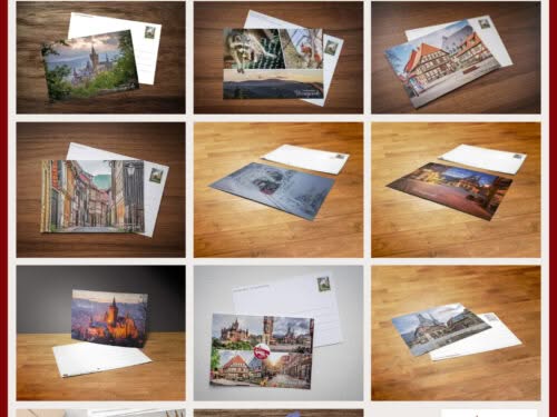 Postcrossing-kennenlern-set-wernigerode Ansichtskarten aus Wernigerode auf Holztisch arrangiert.